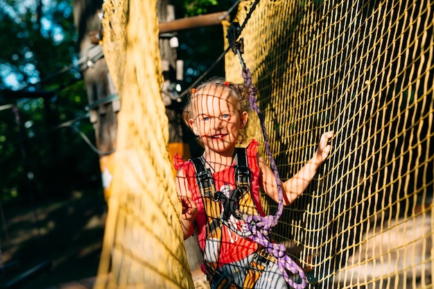 Rope Park. The kid passes the obstacle in the rope Park.