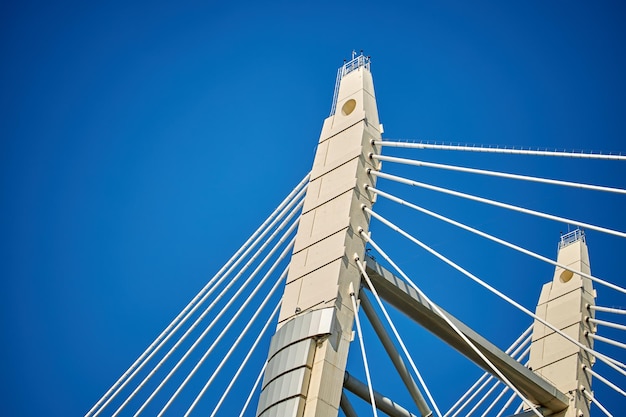 Ropes of a cablestayed bridge against a blue sky