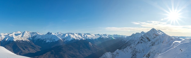 Rosa Khutor ski resort. Mountain landscape of Krasnaya Polyana and sun shining, Sochi, Russia.