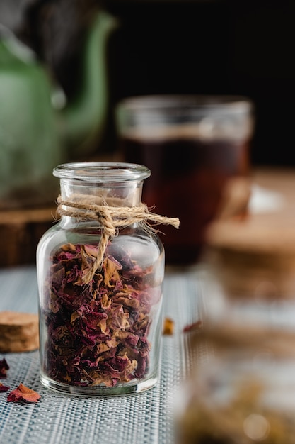 Rose and herbal tea in a small glass bottle