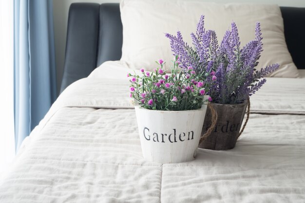 rose and lavender flower on bed in bedroom.