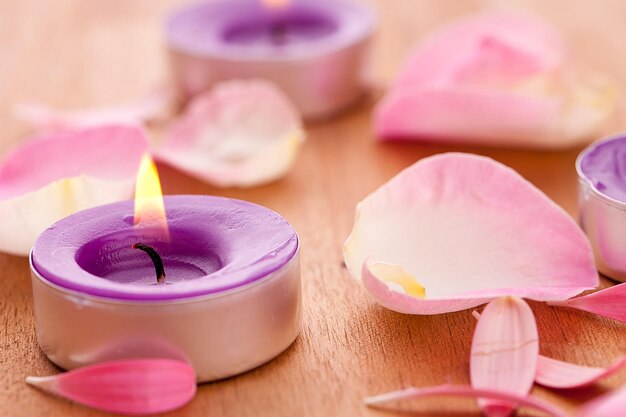 Rose leafs with candel on wooden background