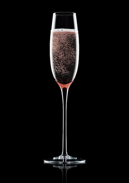 Rose pink champagne glass with bubbles on black