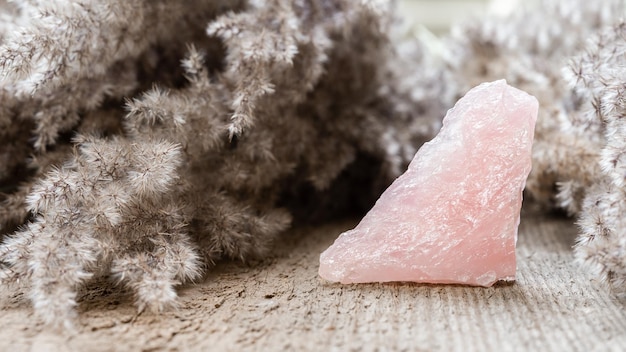 Rose quartz mineral specimen on wooden background