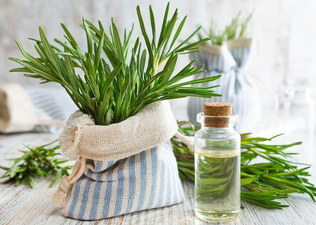 Rosemary essential oil and fresh rosemary.