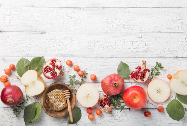 Rosh hashanah - jewish New Year holiday concept. Traditional symbols: Honey jar and fresh apples with pomegranate and shofar horn