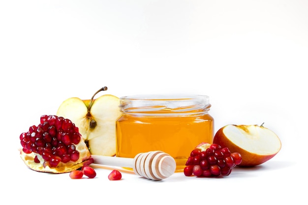 Rosh Hashanakh Jewish holiday Apples pomegranates and honey isolated on white background Traditional Judaism