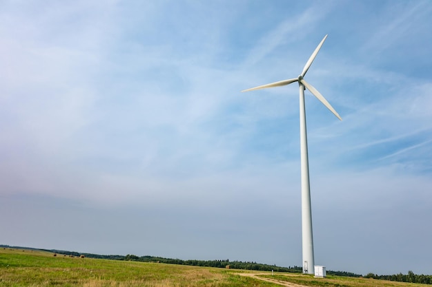 Rotating blades of a windmill propeller on blue sky background Wind power generation Pure green energy