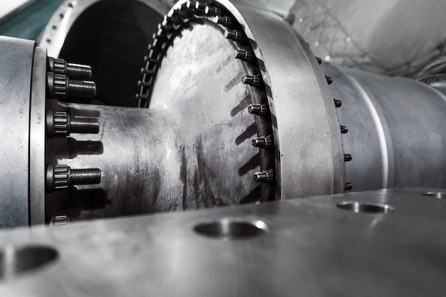 The rotor of a gas turbine compressor with a bolted coupling half. Internal elements of the disassembled turbine