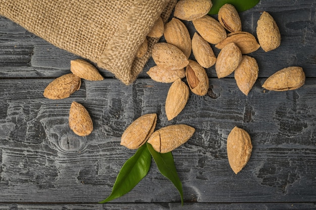 A rough bag with crumbling almonds in the shell