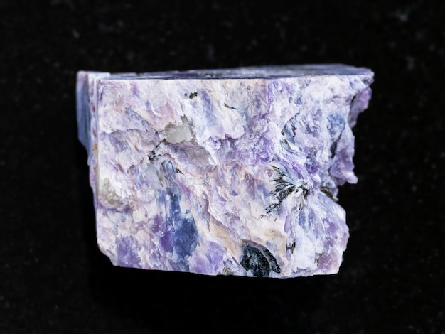 Photo rough charoite stone on dark background