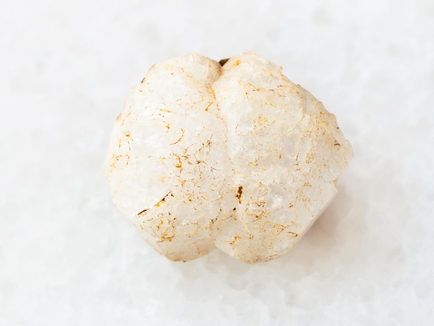 Rough crystal of analcime gemstone on white