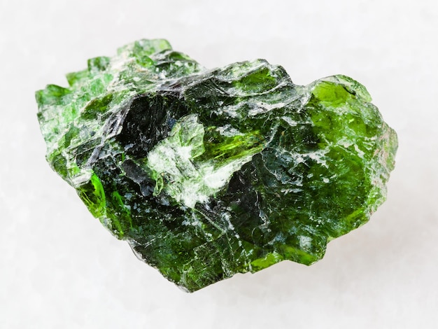 Rough crystal of Chrome Diopside gemstone on white