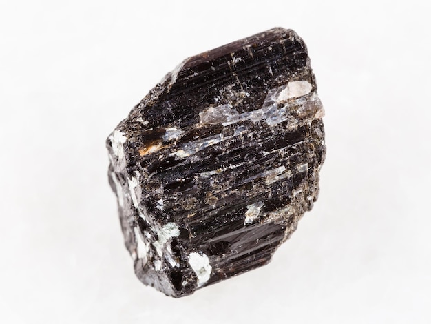 Rough crystal of Schorl tourmaline on white