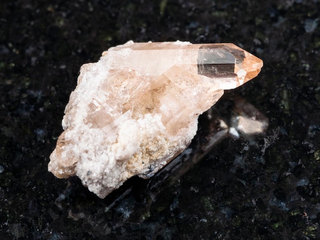 Rough crystal of topaz gemstone on dark background