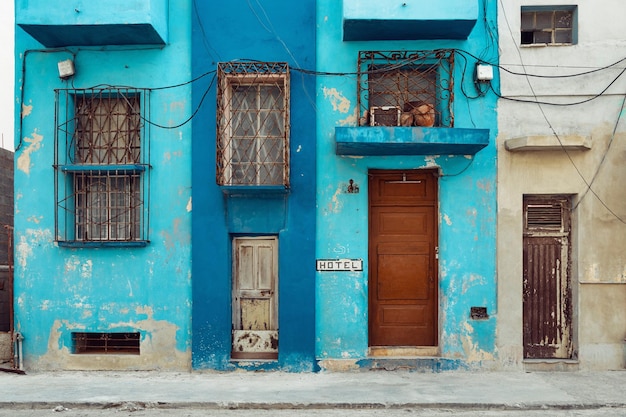 Rough painted facades of buildings with bars on the windows Havana Cuba