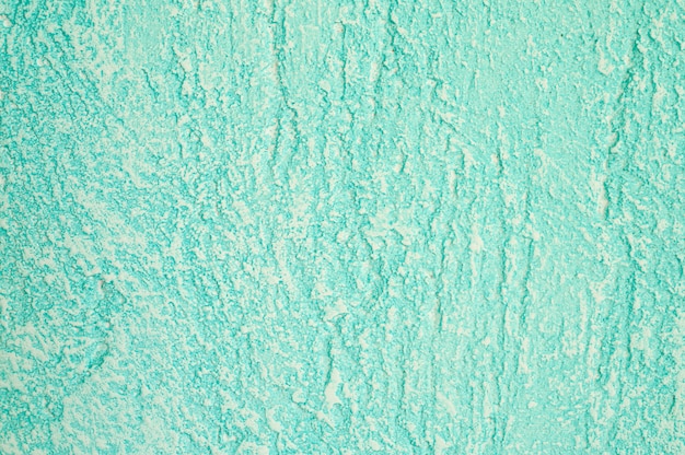 Rough texture of abstract decorative light green background of plaster wall.