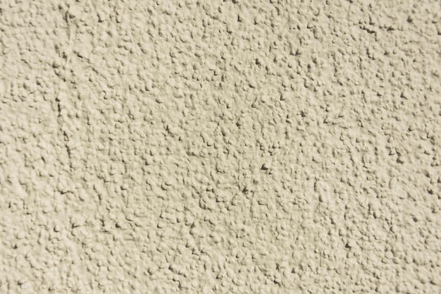 Rough uneven texture beige concrete a wall