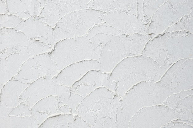 Rough white plaster texture Textured background of filler paste