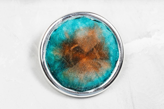 Round brooch with handcolored silk batik on gray