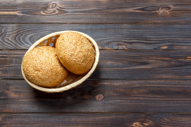 Round buns with seeds. Bread in the basket. Freshly baked bread rolls with seed