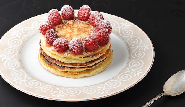 Round cake of several layers with raspberries