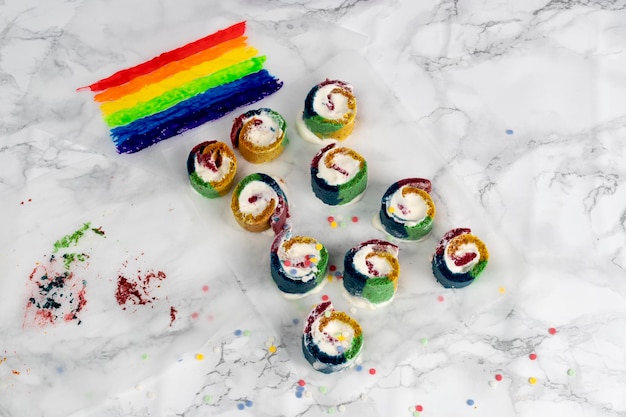 Round colored buns with cream and the rainbow flag symbol of the LGTBI collective