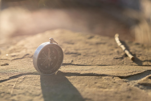 Round compass on the stones as symbol of tourism travel with compass