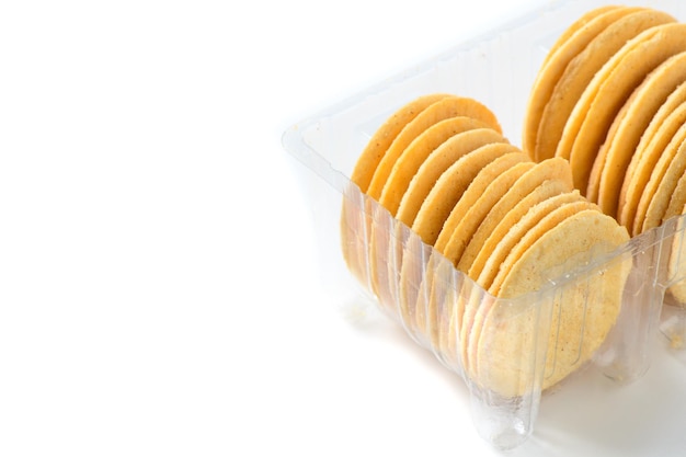 Round Crackers biscuits in plastic box isolated on white background