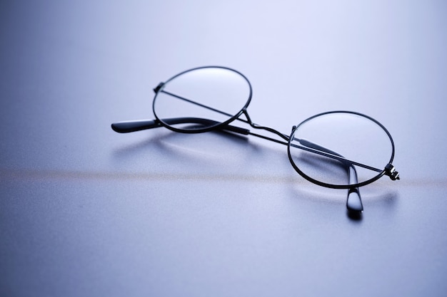 Round eyeglasses on the gray surface