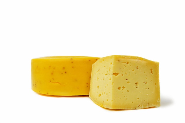 Round head of hard cheese with a small slice on an isolated white background closeup Homemade cheese from the farm The concept of food and healthy lifestyle