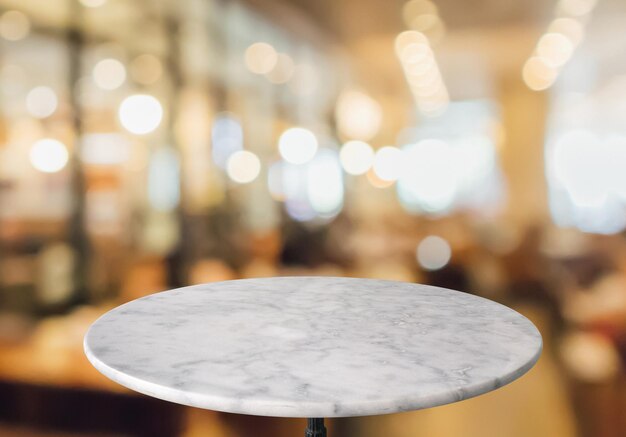 Photo round marble table top with cafe restaurant bokeh lights background for montage product display