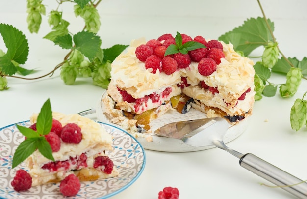 Round meringue pie with fresh raspberries on a white background Pavlova dessert