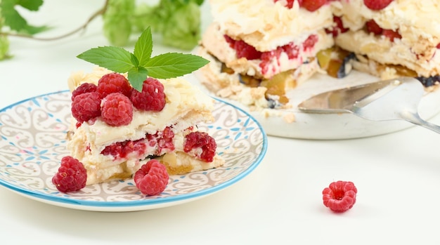 Round meringue pie with fresh raspberries on a white background Pavlova dessert