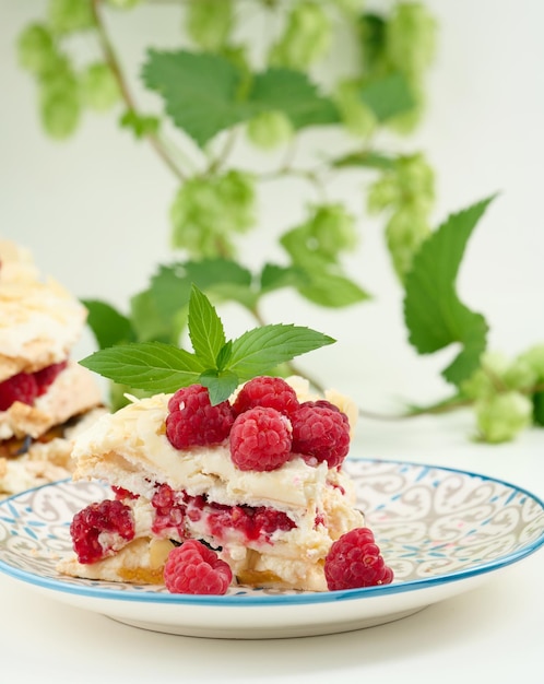 Round meringue pie with fresh raspberries on a white background Pavlova dessert