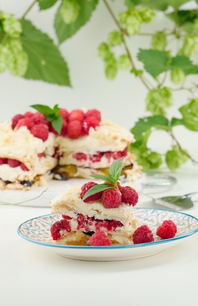 Round meringue pie with fresh raspberries on a white background Pavlova dessert