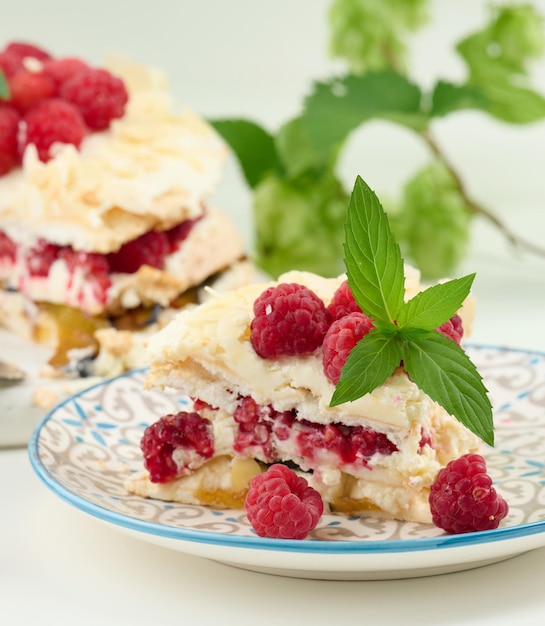 Round meringue pie with fresh raspberries on a white background Pavlova dessert