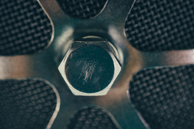 Round metal part with a bolt close-up.