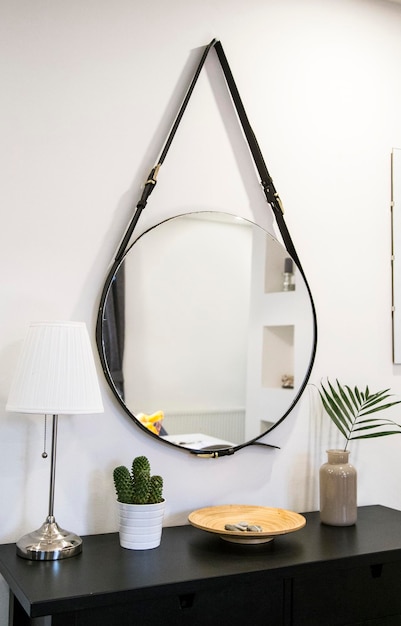 Photo round mirror hanged with leather straps