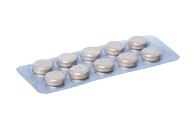 Round pills in blister pack on a white background close up