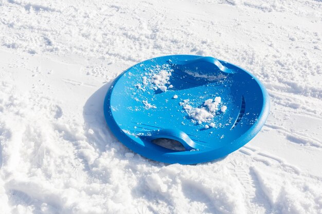 Round plastic sled for winter recreation on the snow