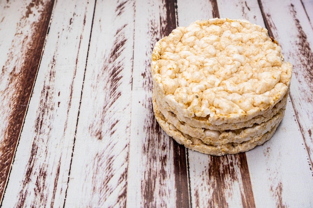 Round rice crackers on a rustic wooden table Copy space Healthy natural food Vegan food