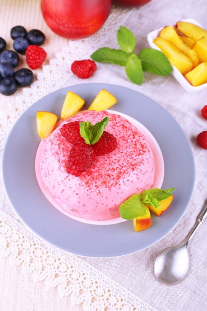 Round shaped cake with fruits and berries on plate on lace napkin