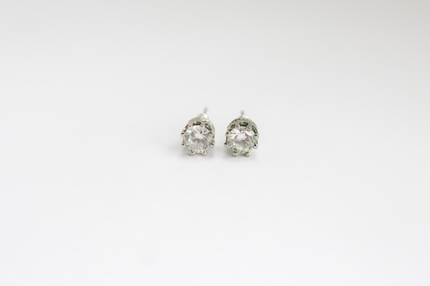 Round silver earrings with diamonds on white