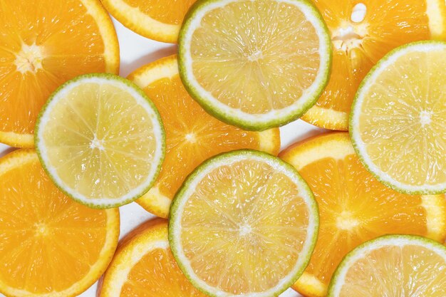 Round slices of juicy orange and lime background for your design