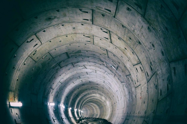 round underground winding subway tunnel going into the distance.