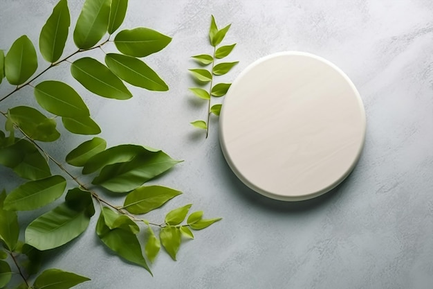 A round white circle with green leaves and a white round stand with a white round top.