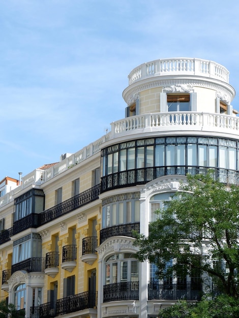 Rounded corner of elegant classical building in Fuencarral district downtown Madrid Spain Vertical