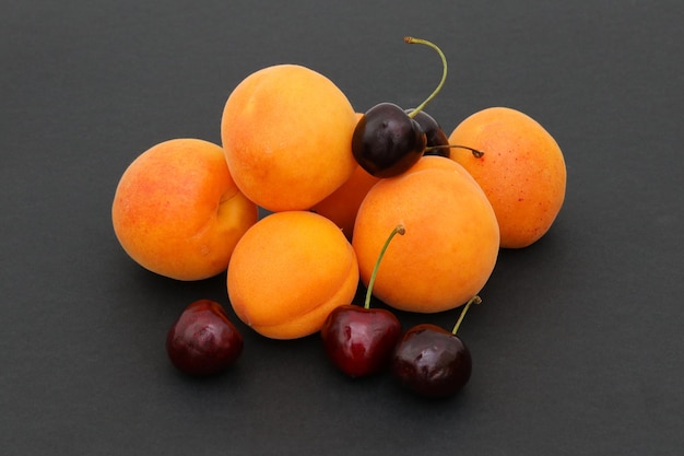 A row of apricots on a black background