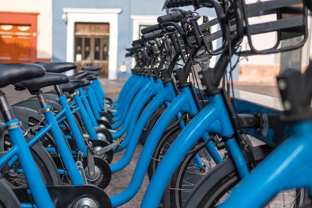 Row of bicycles on the docking station, public bike-sharing mobility system